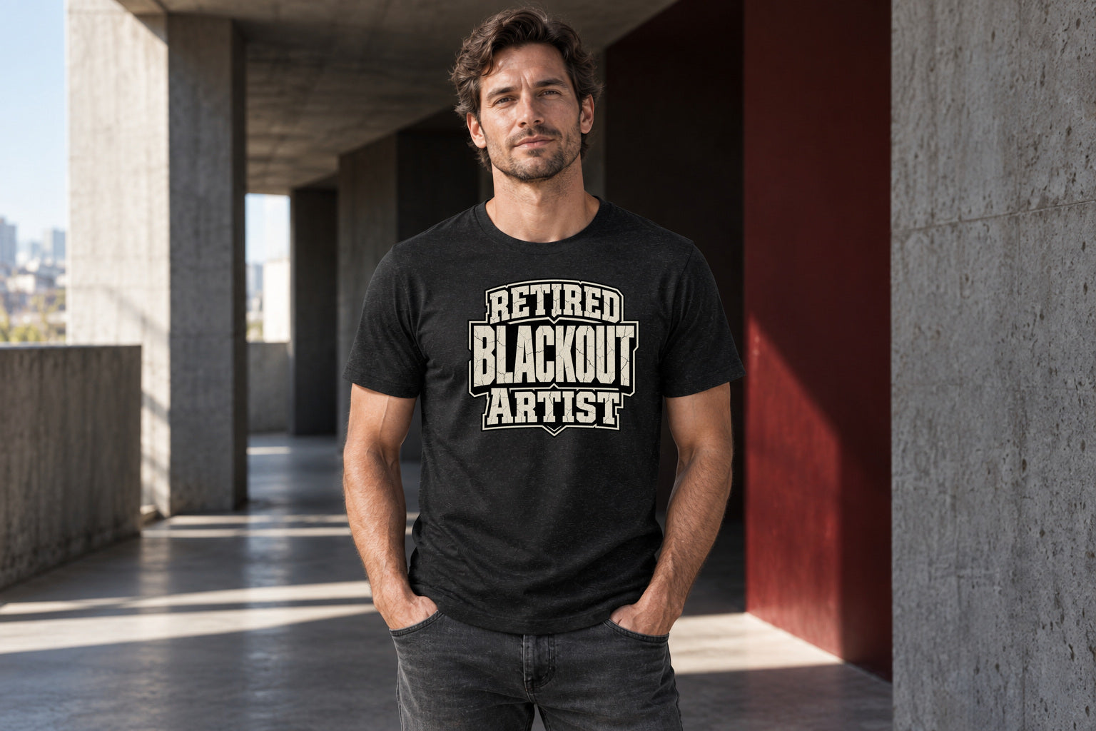 Male model wearing the Retired Blackout Artist Recovery Merch T-shirt against a dark concrete backdrop