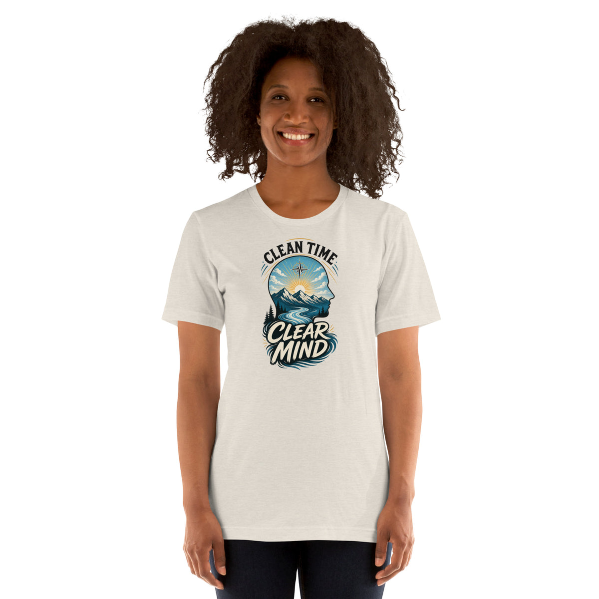 Woman wearing the Heather Dust Clean Time Clear Mind T-shirt with mountain and sunrise artwork.